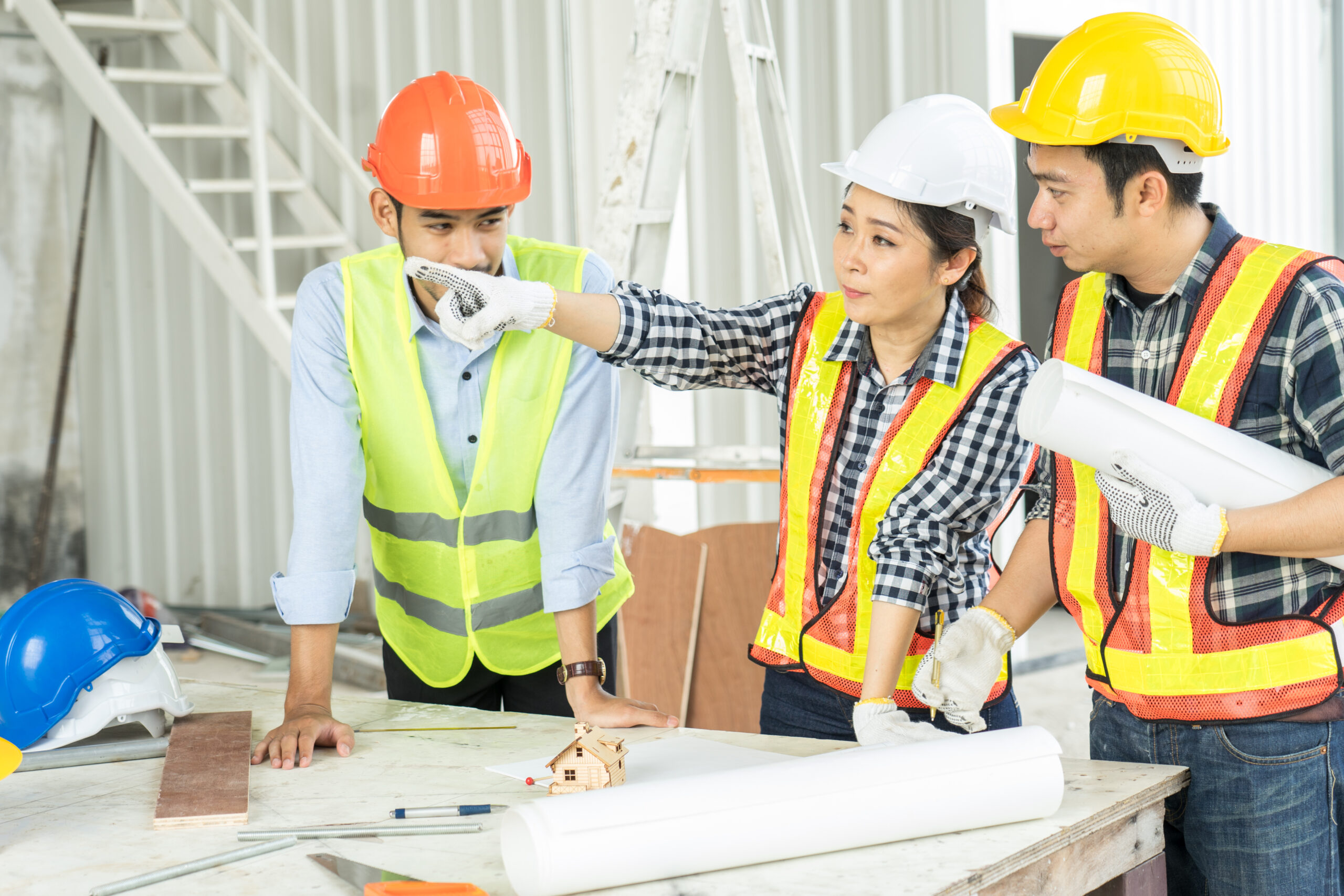 Engineers,Visit,The,Construction,Site.examining,Blueprint,With,Construction,Manager.